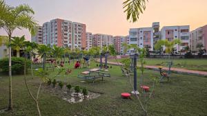 a playground in a park with buildings in the background at Spacious Lakeview Apartment with Balcony in Lucknow