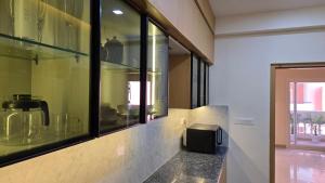 a kitchen with a counter with windows and a counter sidx sidx sidx at Spacious Lakeview Apartment with Balcony in Lucknow