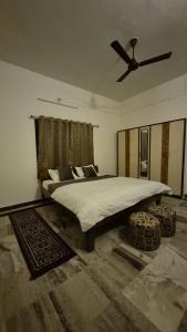 a bedroom with a large bed with a ceiling fan at Jawai Rock Resort in Jawāi Bāndh