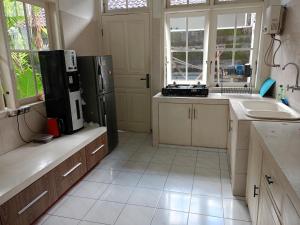 a kitchen with a refrigerator and a sink at Casavina residen kubu manyar 201 in Canggu