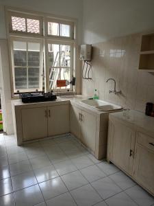 a large kitchen with a sink and a window at Casavina house 201 in Canggu