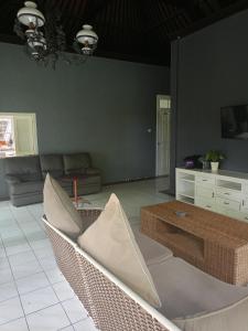 a living room with a couch and a coffee table at Casavina house 201 in Canggu