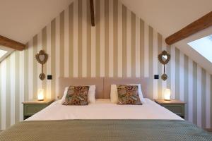 a bedroom with a large bed with two night stands at Casa Cosí in Luxembourg