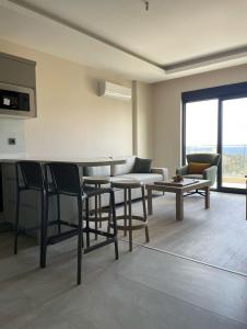 a living room with a table and chairs and a couch at TOROS BULVAR Cozy fancy Sea view next to the Beach and the Mall, in the mid of Alanya Mahmutlar! in Mahmutlar