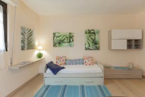 a bedroom with a bed and two paintings on the wall at Lido I Palmizi in Capoliveri