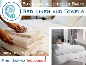 a person putting towels on top of a pile of towels at Sogno Azzurro - ArgonautiVacanze in Porto Azzurro +47 photos