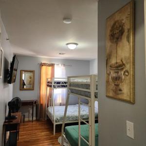 Lovely 3BR Home Quick Trip to NYC Prudential في نيوآرك: غرفة نوم بها سريرين بطابقين في الغرفة +84 صورة