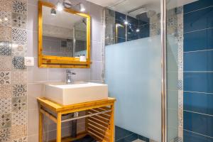 a bathroom with a sink and a mirror at Les Glycines N1 in Les Épesses