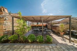 pergolato in legno con tavolo e panche su un patio di Santantimo Tuscany Inn ad Arezzo