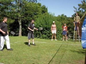 a group of people standing in a field playing tennis at ZEcamping 4 familial animaux acceptés avec piscine et soirées animées in Lons-le-Saunier +98 photos
