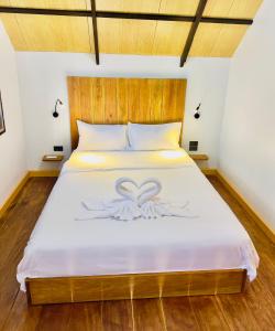 a bedroom with a bed with a heart design on it at Phayam Paradise Resort in Ko Phayam +6 photos