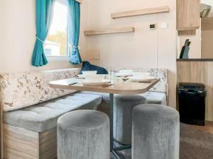 a dining room with a table and stools at Eskside Lodge in Edzell