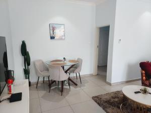 a dining room with a table and chairs at Kwilanzi Apartments in Lusaka