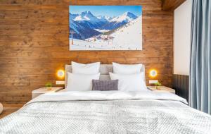 a bedroom with a bed with snow covered mountains at New Gudauri Ski4Life in Gudauri