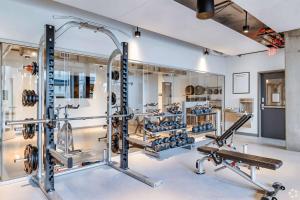 a gym with several treadmills and weights at Panoramic Studio-1BR-3BR, Pool, Gym, Parking, Patio, BBQ in Phoenix