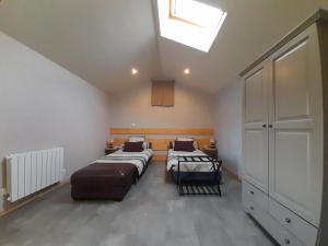 a bedroom with two beds and a skylight at La bergerie in Coussay