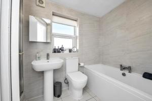 a white bathroom with a toilet and a sink at 17 OutRisbygate St - 3 bedroom house that sleeps 6 with one private parking space in Bury Saint Edmunds +21 photos