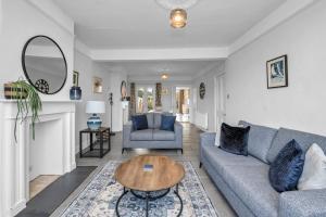 a living room with a couch and a table at 17 OutRisbygate St - 3 bedroom house that sleeps 6 with one private parking space in Bury Saint Edmunds