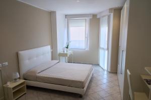 ein Schlafzimmer mit einem Bett und einem Fenster in der Unterkunft Hotel Viña del Mar Pineta in Lido di Jesolo