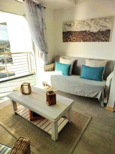 a living room with a couch and a coffee table at 404 Horizon Bay in Bloubergstrand