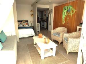 a living room with a bed and a table and chairs at 404 Horizon Bay in Bloubergstrand