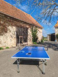 a blue ping pong table in front of a building at Jappeloup in Saint-Germain