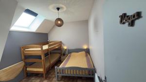 a small room with two bunk beds and a window at Jappeloup in Saint-Germain