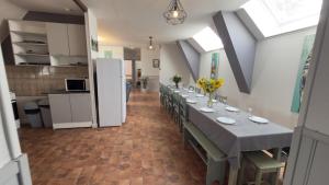 a long dining room with a long table with chairs at Jappeloup in Saint-Germain