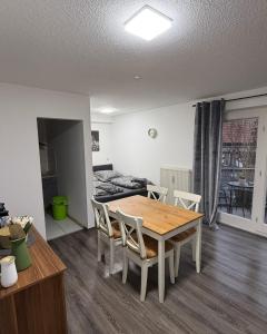 a living room with a wooden table and chairs at FeWo Hess in Rust +7 photos