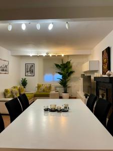a living room with a large white table and chairs at Oasis Rural in Ucero