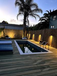 a backyard with a swimming pool and a wooden deck at Pedre Loft in La Pedrera