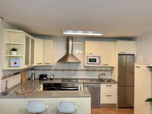 a kitchen with white cabinets and stainless steel appliances at Oasis Rural in Ucero +3 photos