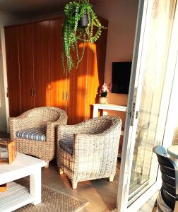 two wicker chairs sitting in a living room at 404 Horizon Bay in Bloubergstrand