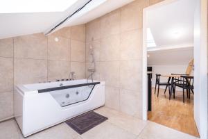 a bathroom with a bath tub in a room at La Maison Bretzel & SPA Medipole - Climatisé in Villeurbanne +21 photos