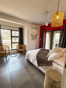 a bedroom with two beds and a table and chairs at Dung Beetle Bush Villa in Marloth Park +23 photos