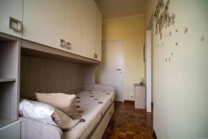 a small bedroom with a bed in a room at Casa Margherita in Vimercate