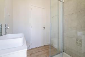 a bathroom with a glass shower and a sink at Downtown 1 Bedroom Apartment E - 150m from the Beach in Albufeira +22 photos