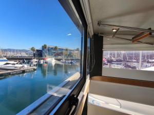 a window on a boat looking out at a marina at Casa Flotante en el Puerto de Vigo - Different Charter in Vigo