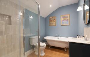 a bathroom with a tub and a toilet and a sink at The Osborne in Shanklin +34 photos