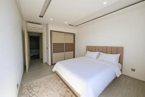 a bedroom with a large white bed in it at Luxury 2 Bedroom Apartment Menzah 9C Near the airport in Tunis