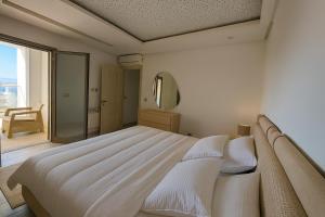 a bedroom with a large bed with a large window at Luxury 2 Bedroom Apartment Menzah 9C Near the airport in Tunis