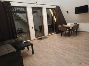 a living room with a couch and a table and chairs at "Гірська гармонія" in Izki