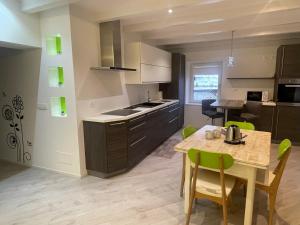 a kitchen and dining room with a table and chairs at Casa Tilì in Ziano di Fiemme