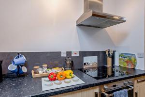 a kitchen with a counter with fruits and vegetables on it at Gwilym's Stable in Builth Wells