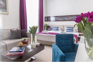 a living room with a couch and a bed at Theater Hotel Belgrade in Belgrade