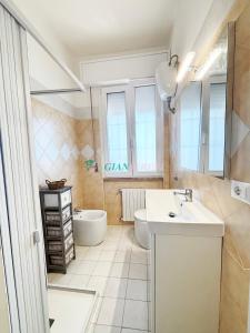 a bathroom with a sink and a toilet and a tub at Casabianca in San Vincenzo