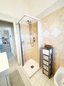 a shower in a bathroom with a sink at Casabianca in San Vincenzo +51 photos