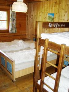 a bedroom with two bunk beds in a cabin at Moaralmhütte in Görtschach