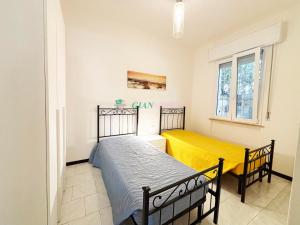 a bedroom with two beds and a window at Casabianca in San Vincenzo