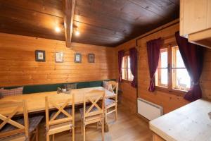 a dining room with a wooden table and chairs at Samerhaus in Hüttschlag +17 photos